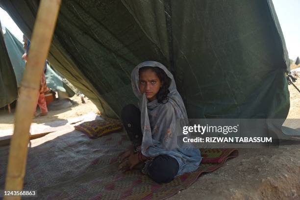 An internally displaced flood-affected girl sits in a makeshift tent at a camp in Kotri of Jamshoro district, Sindh province on September 28, 2022.