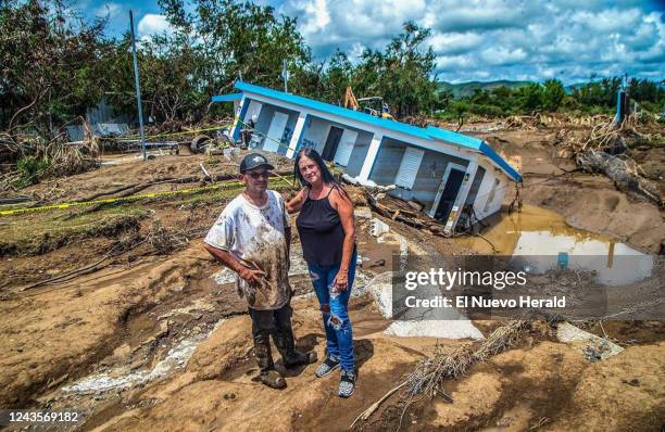 Leida Rodriguez and Javier Castellanos stand in front of their house that collapsed into a sinkhole after being flooded with water and mud during...