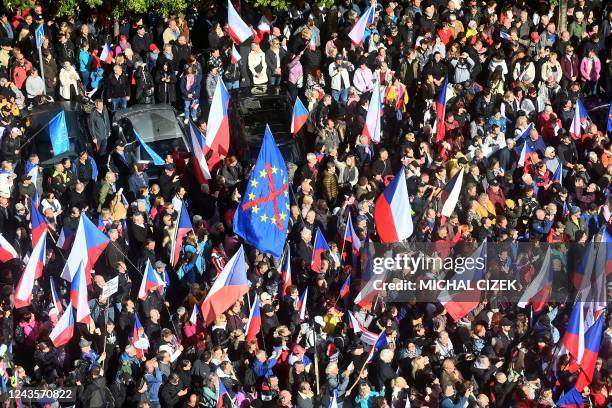 Several thousands of protesters including groups from the far-right and far-left wave Czech national flags as they take part in rally against the...