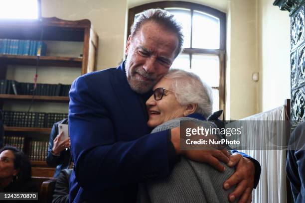 Arnold Schwarzenegger hugs Lidia Maksymowicz, holocaust survivor, during a visit inside a former synagogue that now is home to the Auschwitz Jewish...