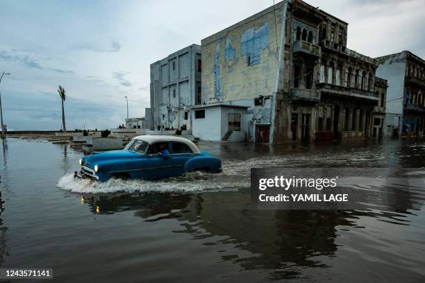 An old American car passes through a flooded street in Havana, on September 28 after the passage of hurricane Ian. Cuba exceeded 12 hours this...