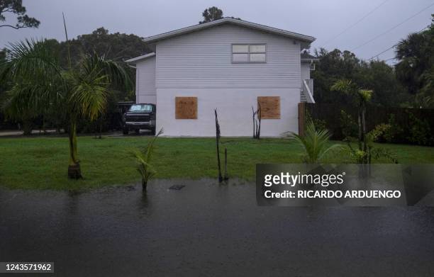 The yard of a home is partially flooded ahead of Hurricane Ian in Punta Gorda, Florida on September 28, 2022. - Ian intensified to just shy of...