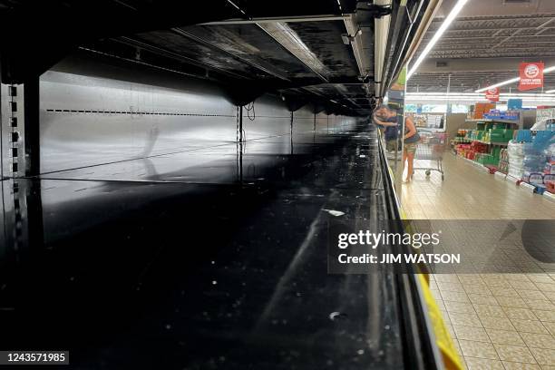Grocery store shelves lay empty at Aldis in Titusville, Florida, on September 28 as the eastern coast of central Florida braces for Hurricane Ian. -...
