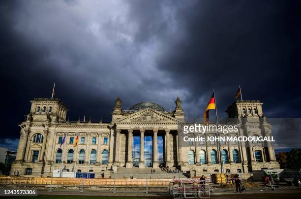 Rain clouds gather over the Reichstag building which houses Germany's lower house of parliament in Berlin on September 28, 2022.