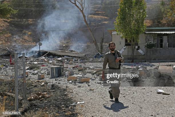 Kurdish peshmerga fighter inspects the damage following an Iranian cross-border attack in the area of Zargwez, where several exiled left-wing Iranian...