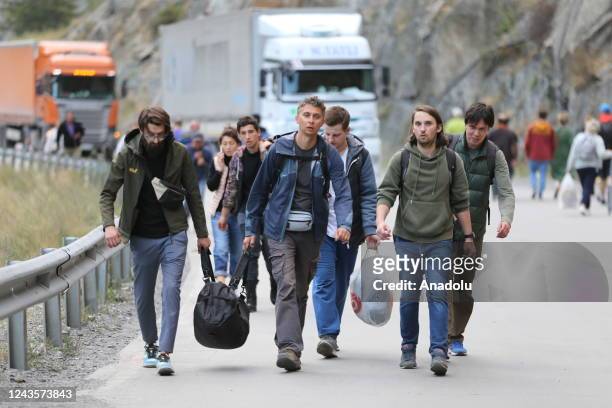 Russians are seen attempting to leave their country to avoid a military call-up for the Russia-Ukraine war as queues have formed at the Kazbegi...