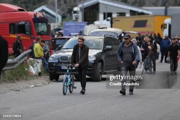 Russians are seen attempting to leave their country to avoid a military call-up for the Russia-Ukraine war as queues have formed at the Kazbegi...