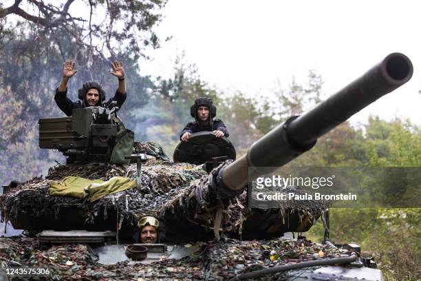 Ukrainian mechanic helps to test drive a repaired Russian tank in a wooded area outside the city on September 26 2022 in Kharkiv, Ukraine. Mechanics...