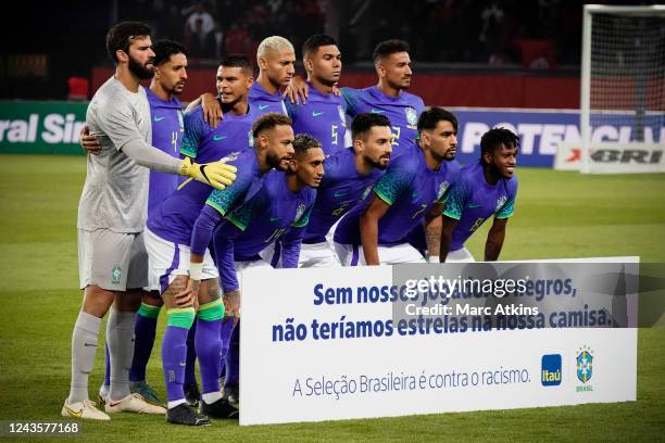 Brazil players pose with an anti-racism banner reading "Without our black players, we wouldn't have stars on our shirts" prior to the International...