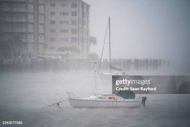 Wind gusts blow across boats in the Sarasota Bay as Hurricane Ian churns to the south on September 28, 2022 in Sarasota, Florida. The storm made a...