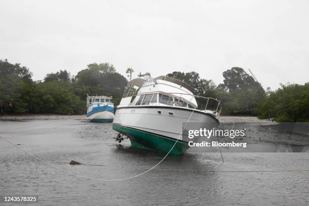 Boat sways in shallow water as Hurricane Ian approaches in the Coquina Key neighborhood of St. Petersburg, Florida, US, on Wednesday, Sept. 28, 2022....