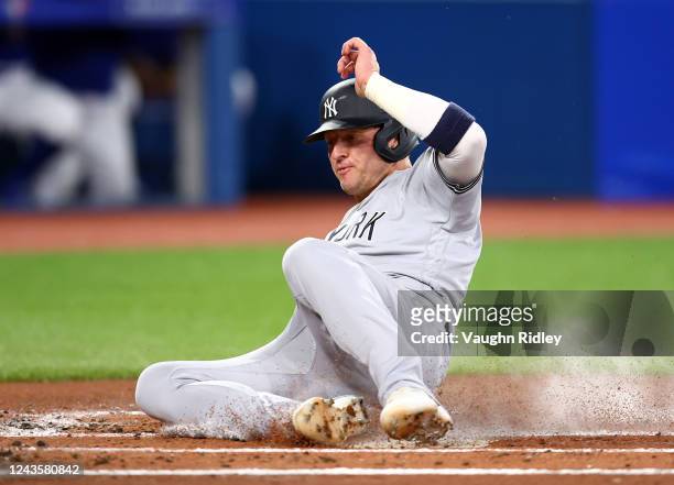 Josh Donaldson of the New York Yankees scores on a sacrifice fly by Marwin Gonzalez in the first inning against the Toronto Blue Jays at Rogers...