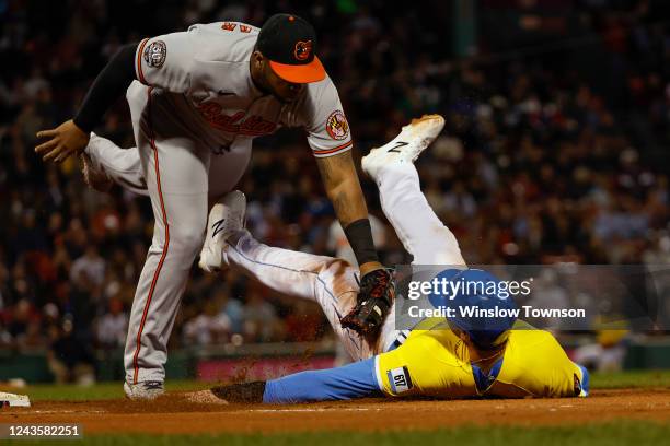 Triston Casas of the Boston Red Sox is picked off first base on the tag by Jesus Aguilar of the Baltimore Orioles during the second inning at Fenway...