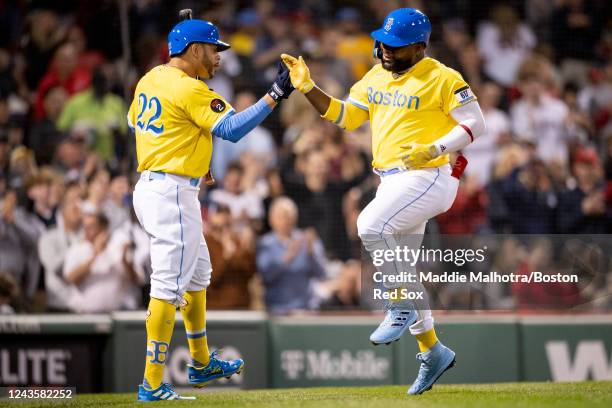 Abraham Almonte of the Boston Red Sox reacts with Tommy Pham of the Boston Red Sox after hitting a home run during the third inning of a game against...