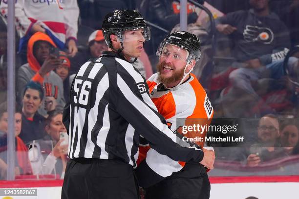 Linesmen Julien Fournier restrains Nicolas Deslauriers of the Philadelphia Flyers from getting into a fight against the Washington Capitals in the...