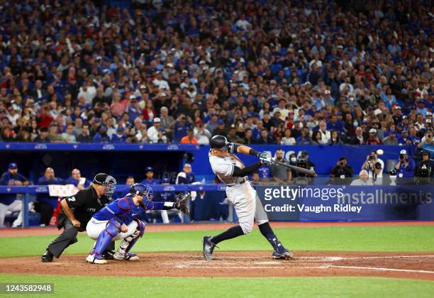 Aaron Judge of the New York Yankees hits his 61st home run of the season in the seventh inning against the Toronto Blue Jays at Rogers Centre on...