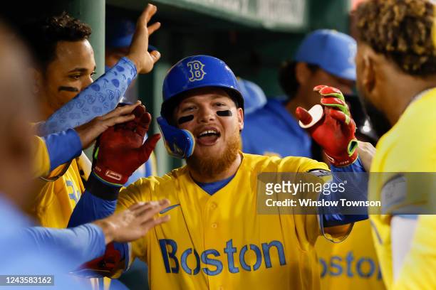 Alex Verdugo of the Boston Red Sox is congratulated in the dugout after his home run against the Baltimore Orioles during the sixth inning at Fenway...