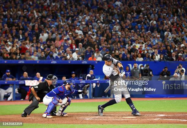Aaron Judge of the New York Yankees hits his 61st home run of the season in the seventh inning against the Toronto Blue Jays at Rogers Centre on...