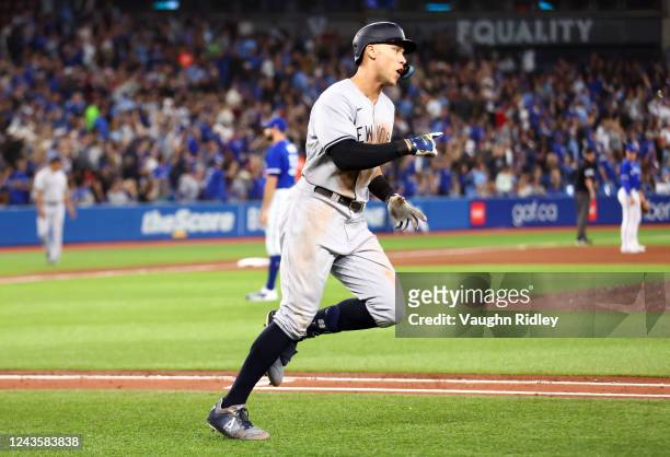 Aaron Judge of the New York Yankees celebrates after hitting his 61st home run of the season in the seventh inning against the Toronto Blue Jays at...