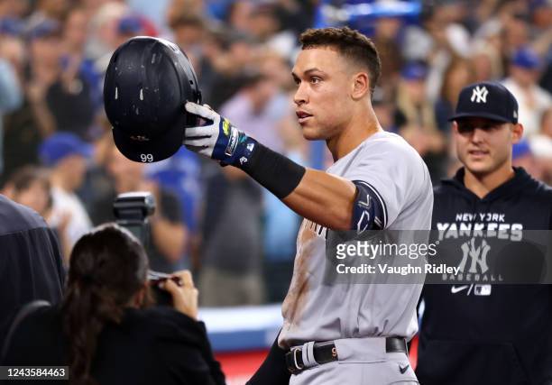 Aaron Judge of the New York Yankees tips his hat towards his mother after hitting his 61st home run of the season in the seventh inning against the...