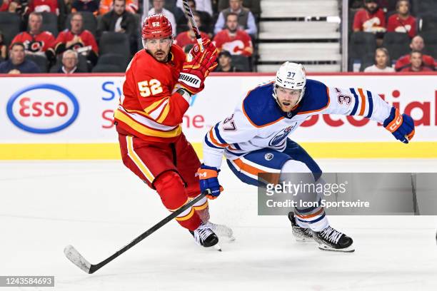 Calgary Flames Defenceman MacKenzie Weegar and Edmonton Oilers Left Wing Warren Foegele compete for position during the second period of an NHL...