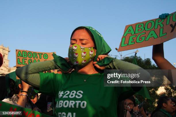 Legal Abortion Now" can be read on a cardboard when hundreds of women, wearing green scarf, carry out a demonstration demanding "Legal, safe and free...