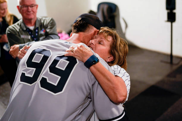 Aaron Judge of the New York Yankees hugs his mother, Patty, after defeating the Toronto Blue Jays and tying Roger Maris AL home run record at Rogers...