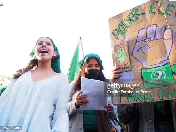 Be able to Choose" can be read on a cardboard when hundreds of women, wearing green scarf, carry out a demonstration demanding "Legal, safe and free...