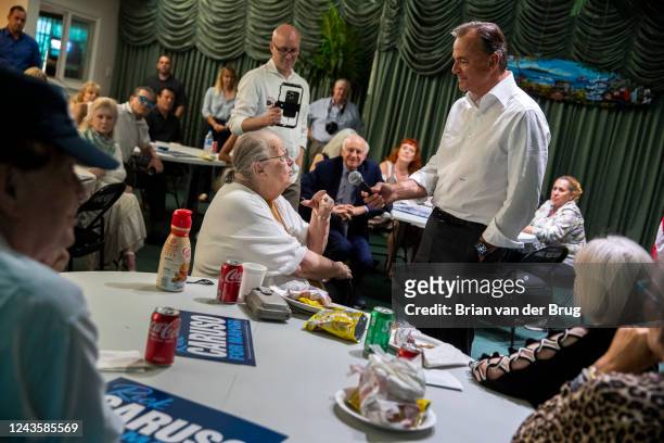 September 28, 2022 - Los Angeles mayoral candidate Rick Caruso, right, holds a microphone as he takes a question from Gloria Pollack, left, during a...