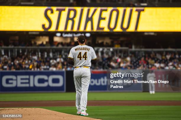 Joe Musgrove of the San Diego Padres walks off the back of the mound after a strikeout in the first inning against the Los Angeles Dodgers at PETCO...