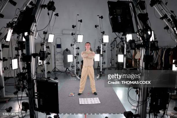 An employee of Peris Costumes takes the pose to be photographed in a studio equipped with 144 high-resolution cameras set to digitise the costumes in...