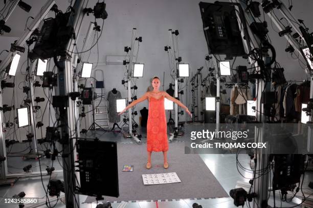 An employee of Peris Costumes takes the pose to be photographed in a studio equipped with 144 high-resolution cameras set to digitise the costumes in...