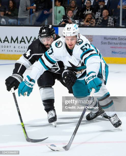 Nate Thompson of the Los Angeles Kings and Adam Raska of the San Jose Sharks battle for the puck during the third period during the preseason game at...