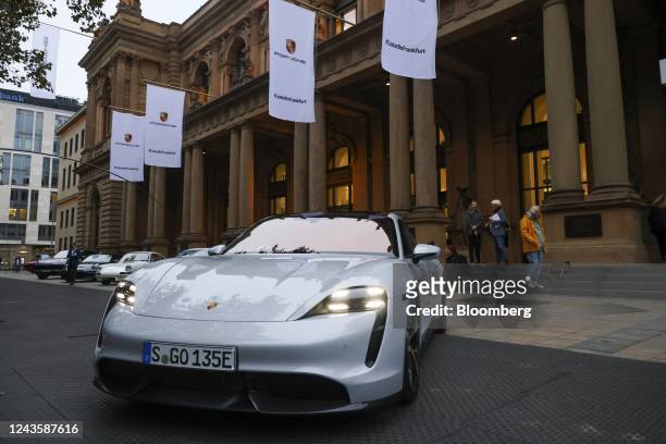 Porsche luxury automobiles outside the Frankfurt Stock Exchange, operated by Deutsche Boerse AG, ahead of the Porsche AG initial public offering in...