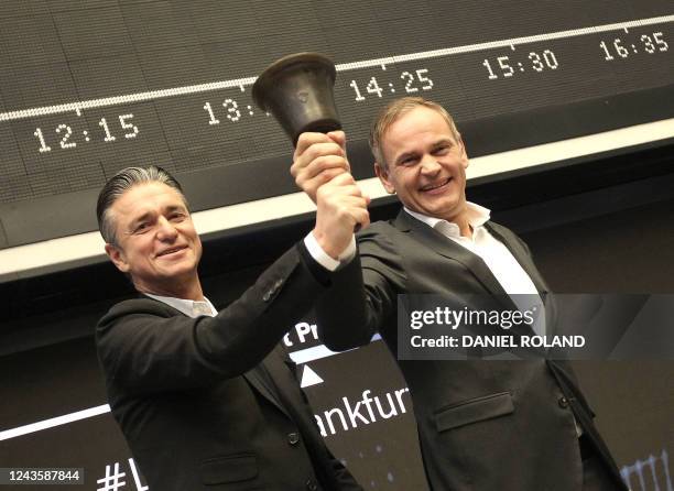 Oliver Blume , CEO of German car producer Porsche AG, and Lutz Meschke, member of the Porsche management board, ring the bell to launch the company's...