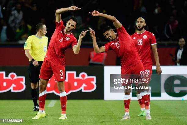 Montassar Talbi of Tunisia celebrates with Mohamed Drager after making the score 1-1 during the International Friendly between Brazil and Tunisia at...