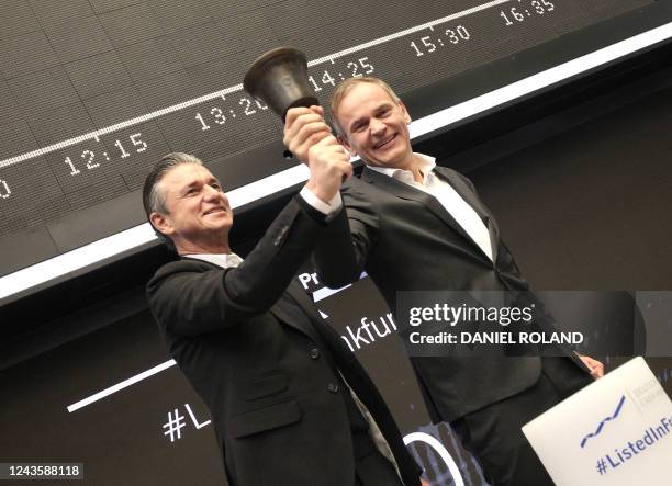 Oliver Blume , CEO of German car producer Porsche AG, and Lutz Meschke, member of the Porsche management board, ring the bell to launch the company's...