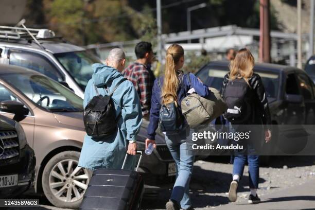 Russians are seen attempting to leave their country to avoid a military call-up for the Russia-Ukraine war as queues have formed at the Kazbegi...