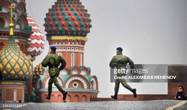 Russian soldiers run along Red Square in central Moscow on September 29 as the square is sealed prior to a ceremony of the incorporation of the new...