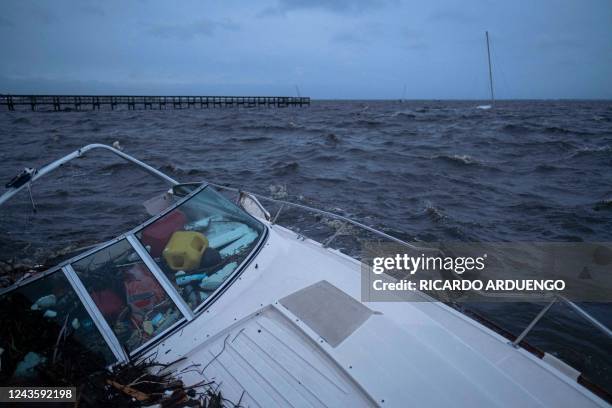 Boat lies partially submerged in the aftermath of Hurricane Ian in Punta Gorda, Florida, on September 29, 2022. - Hurricane Ian left much of coastal...