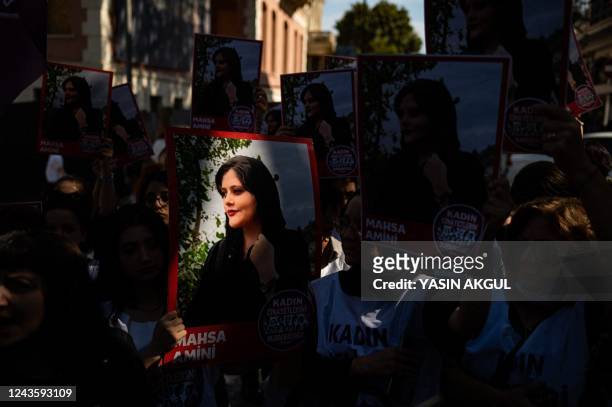 Protestors hold banners with the portrait of Iranian Mahsa Amini as they take part in a rally outside the Iranian consulate in Istanbul on September...