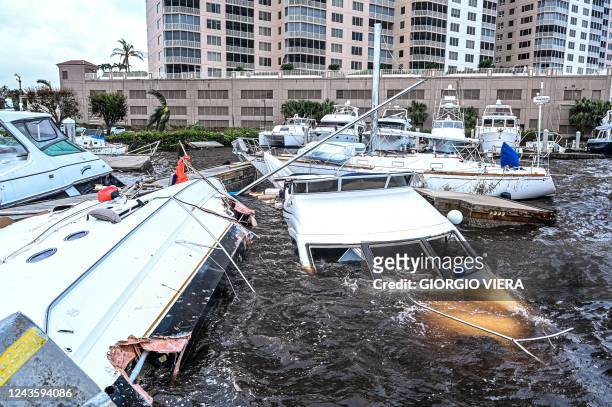 Boat are partially submerged at a marina in the aftermath of Hurricane Ian in Fort Myers, Florida, on September 29, 2022. - Hurricane Ian left much...