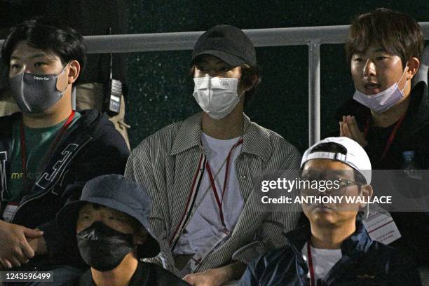 South Korean K-Pop boy band BTS member Kim Seok-jin , also known as Jin, watches the men's singles match between Norway's Casper Ruud and Chile's...