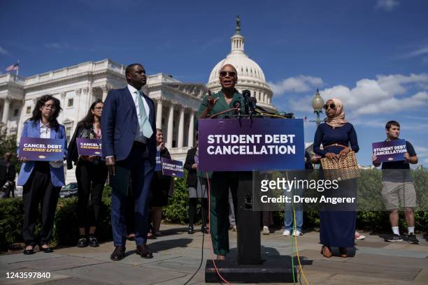 Rep. Ayanna Pressley speaks as Rep. Mondaire Jones and Rep. Ilhan Omar look on during a news conference to discuss student debt cancellation on...
