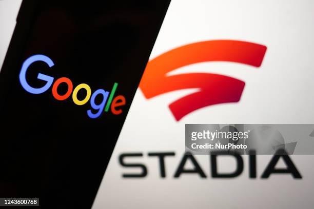 Stadia logo displayed on a laptop screen and Google logo displayed on a phone screen are seen in this illustration photo taken in Krakow, Poland on...
