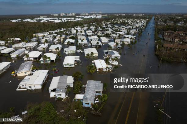 An aerial picture taken on September 29, 2022 shows a flooded neighborhood in the aftermath of Hurricane Ian in Fort Myers, Florida. - Hurricane Ian...
