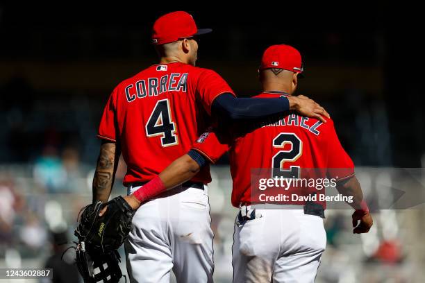 Carlos Correa and Luis Arraez of the Minnesota Twins embrace in the seventh inning of the game against the Chicago White Sox at Target Field on...