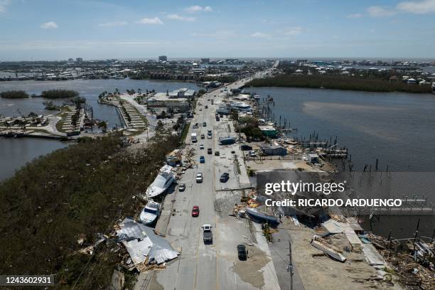 An aerial picture taken on September 29, 2022 shows washed up boats on a street in the aftermath of Hurricane Ian in Fort Myers, Florida. - Hurricane...