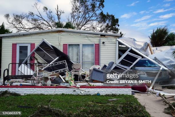 Roof is collapsed onto a minivan in the aftermath of Hurricane Ian in Marylu Park, Charlotte Harbor, Florida on September 29, 2022. - Hurricane Ian...