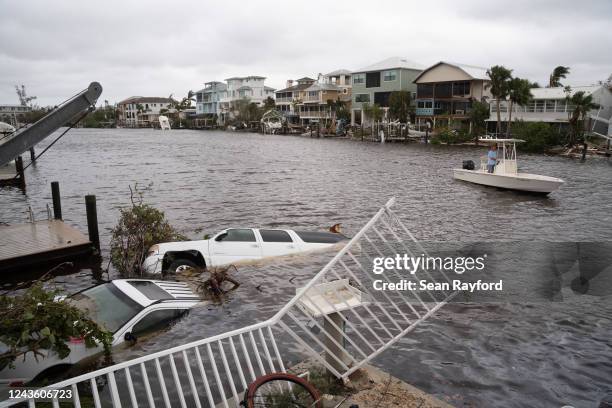 Vehicles float in the water after Hurricane Ian on September 29, 2022 in Bonita Springs, Florida. Hurricane Ian brought high winds, storm surge and...